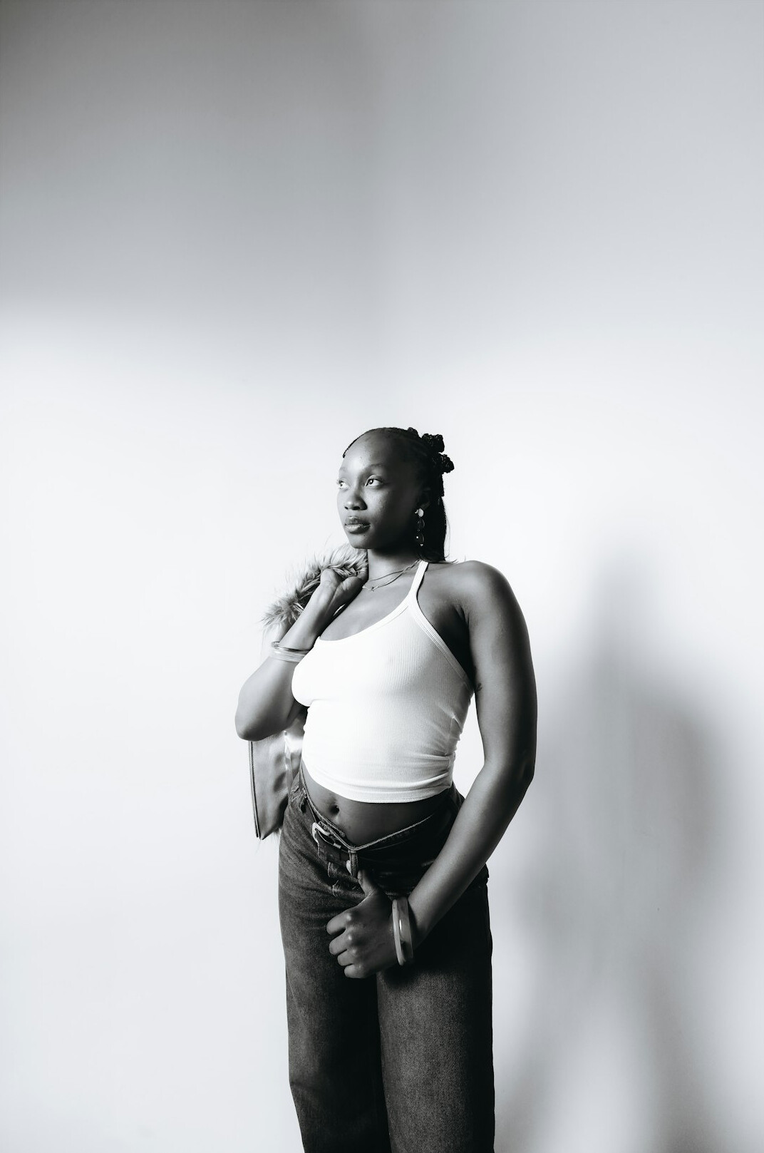 Confident woman speaking into a microphone in a minimalist studio
