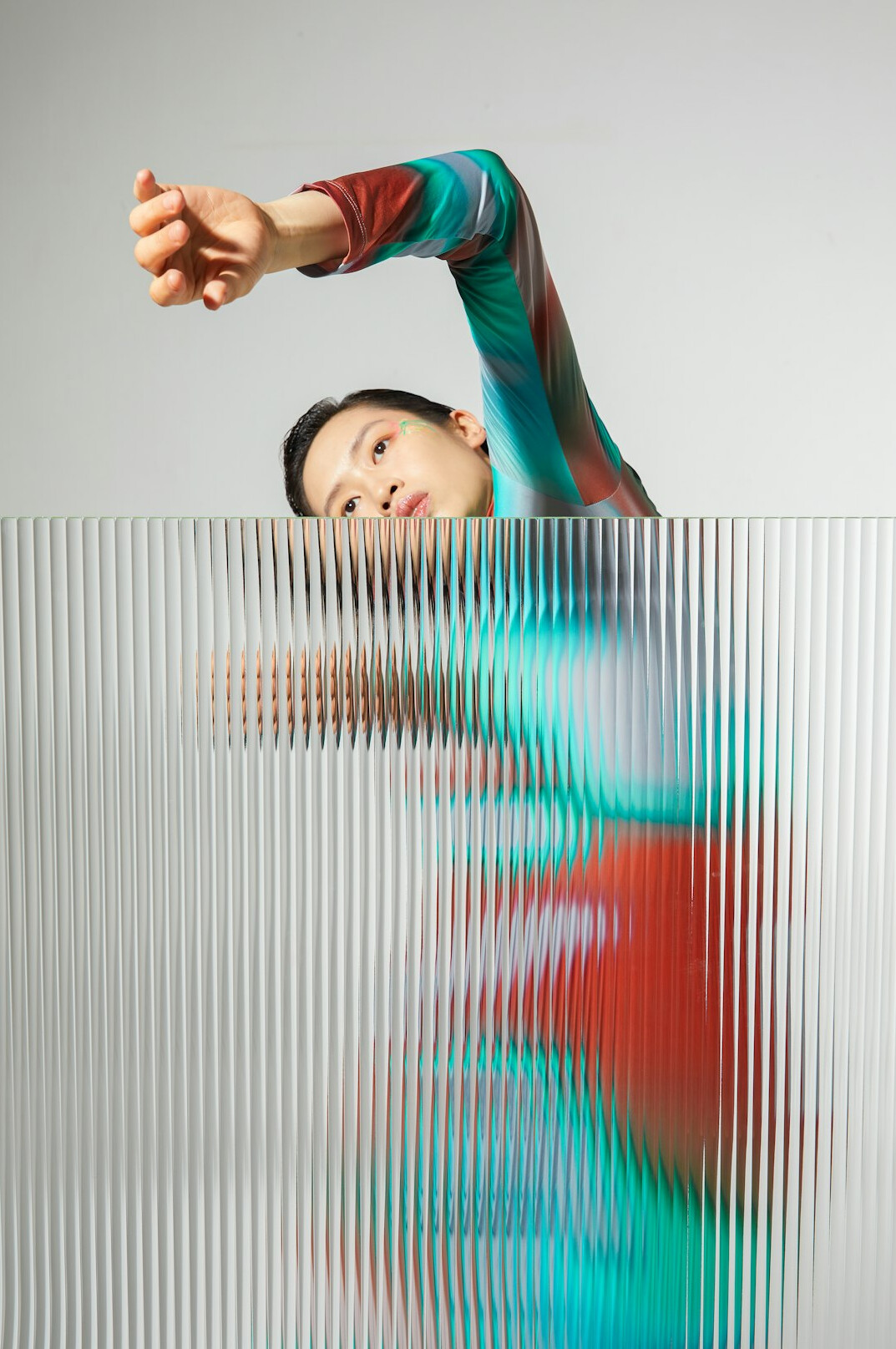 Man practicing posture and gesture in front of a studio mirror